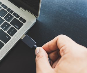 Close up of a man's right hand Going to connect the USB cable, take the external data into the laptop