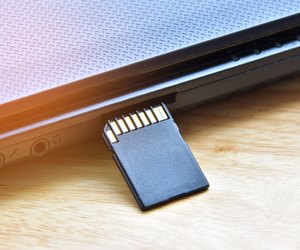 Close-Up Of Memory Card By Laptop On Table