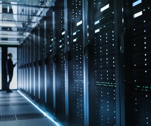 Photo of Out of Focus IT Technician Turning on Data Server.