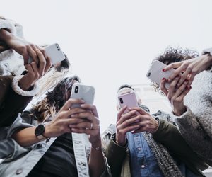 Group of friends in the street with smartphone