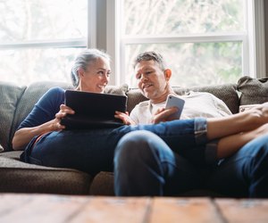 Mature Couple Relaxing with Tablet and Smartphone