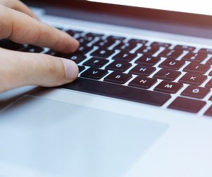 Hands typing on laptop computer