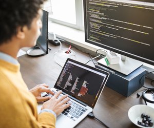 Computer programmer working at his desk