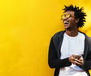 Portrait of handsome afro man using his mobile.