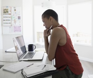 Mature woman using laptop in kitchen