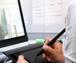 Female graphic designer using tablet pen