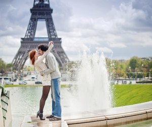 Loving couple kissing near the Eiffel Tower in Paris