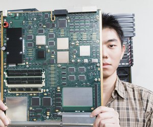 Computer technician holding motherboard