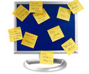 flatscreen monitor with notes written on it