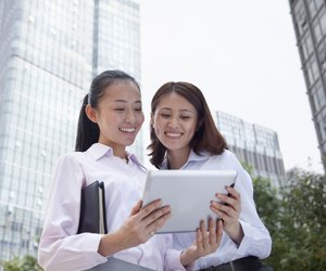 Two young businesswomen discussing outdoors