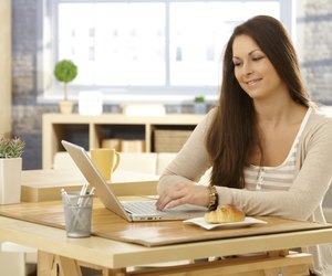 Young woman with laptop in the morning