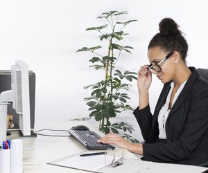 Young office worker looks at monitor