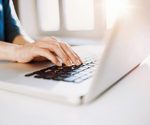 Female hand on a laptop keyboard