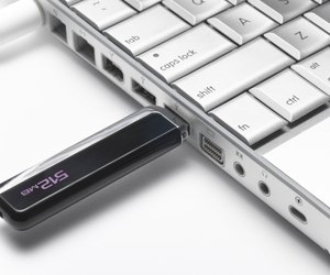 USB flash hard drive plugged into laptop, close-up