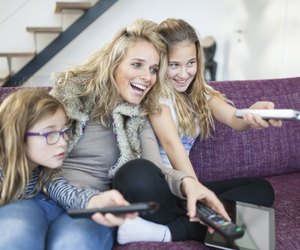Family changing channels on the television