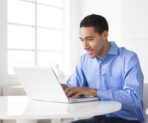 Working on his laptop