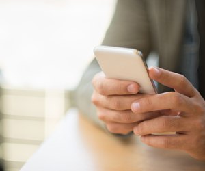 man typing text message