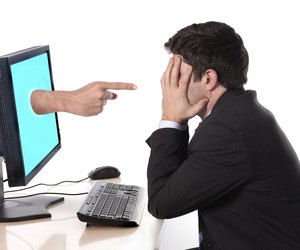 Business man with computer in stress concept