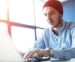 Handsome man working from his home office. Analyze business plans