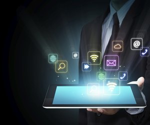 Tablet with cloud of colorful application icons
