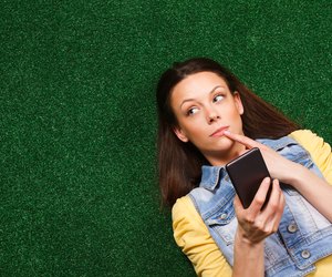 Woman thinking while texting message
