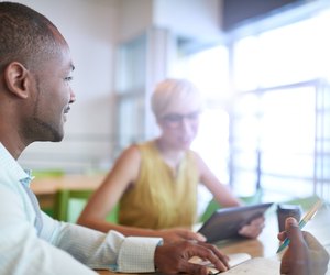 Two creative millenial small business owners working on social media