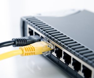 Network switch device and ethernet cables on white