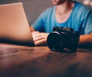 Man doing postproduction of his photos on laptop at night