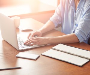 Cropped view of a young businesswoman typing on her laptop