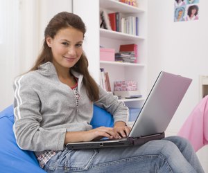 Teenage girl using laptop computer