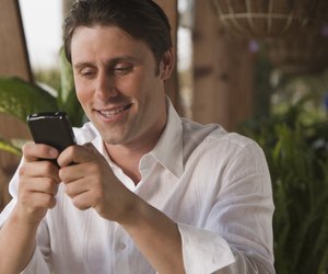 Smiling man using PDA