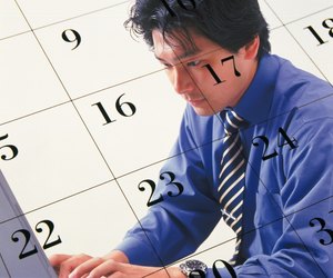 Businessman using laptop and image of calendar, CG, composition, side view