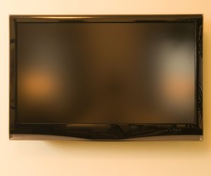Television hanging on wall