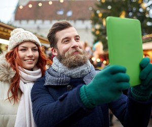couple taking selfie with tablet pc in old town