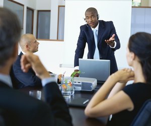 Three businessmen and a businesswoman in a meeting