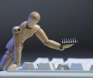Figurine fixing broken keyboard