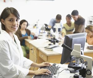 Portrait of a lab technician in front of a computer monitor