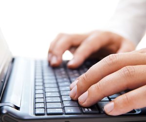 Businessman working on laptop over white