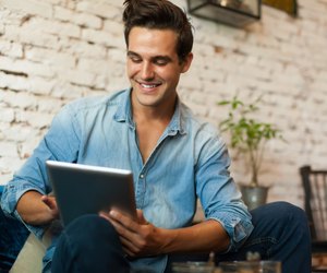 Casual Man Using Tablet Computer Smile