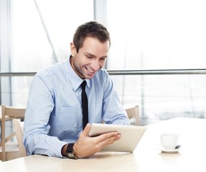Businessman with digital tablet smiling