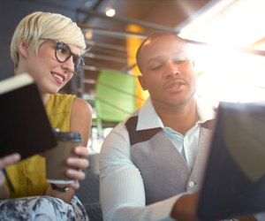 Two creative millenial small business owners working on social media