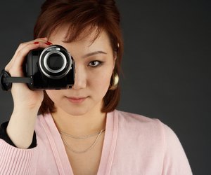 Woman filming with video camera