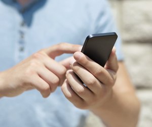 boy holding phone and a touch screen for finger