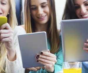 Friends surfing the net with smartphones and digital tablets