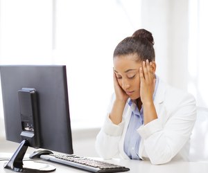 stressed african woman with computer