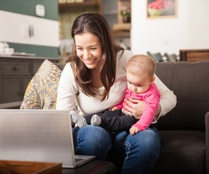 Young mom working at home with her baby
