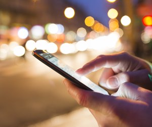 Man using his Mobile Phone in the street, bokeh