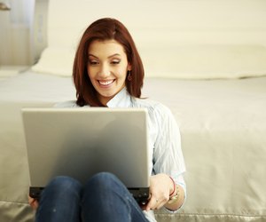 Happy woman sitting with laptop