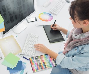 Artist drawing something on graphic tablet at office