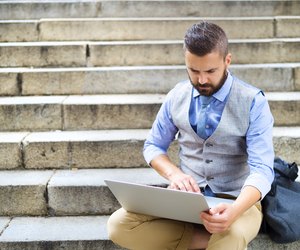 Hipster businessman with laptop